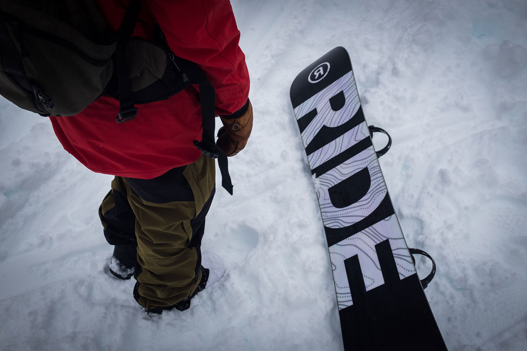 Jake Welch stands next to his RIDE Snowboard